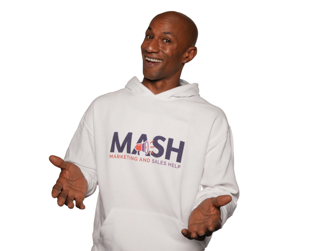 Adam Ace Spencer smiling in a white MASH sweatshirt with his hands open