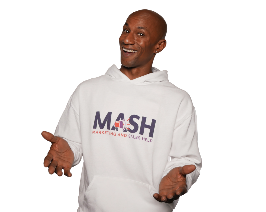 Adam Ace Spencer smiling in a white MASH sweatshirt with his hands open